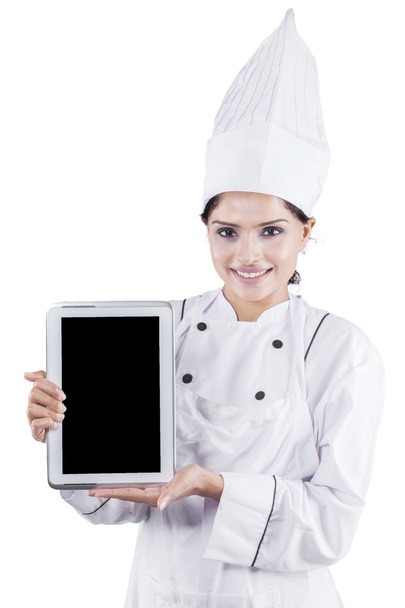 Female chef shows digital tablet - Foto, afbeelding