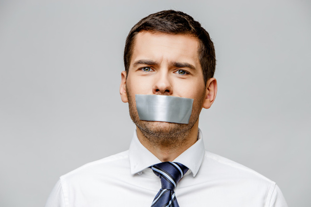 businessman with tape sealed mouth - Фото, зображення