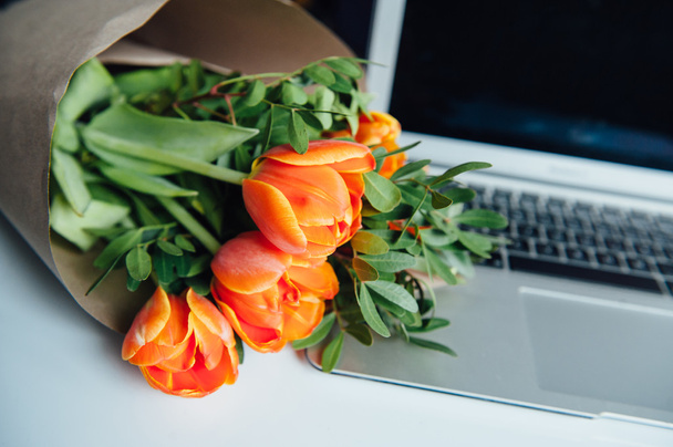 Laptop on white floor with flowers - Photo, image