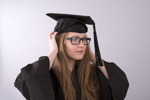Graduate wearing a cap and gown - Photo, Image