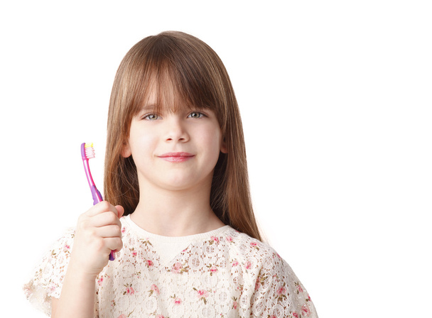 girl holding a toothbrush - Foto, afbeelding