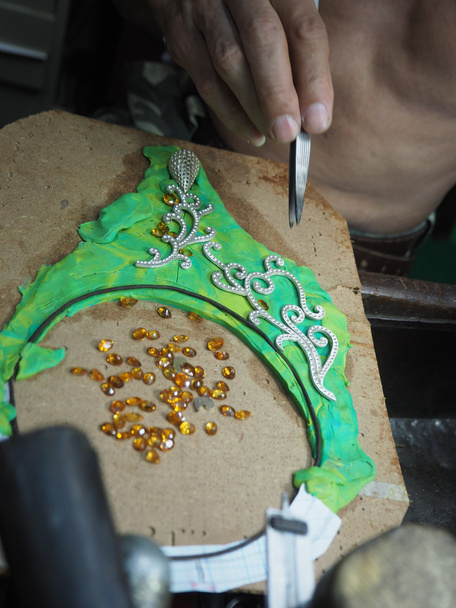 Goldsmith working on an unfinished  gold with his hard working hands - Photo, Image