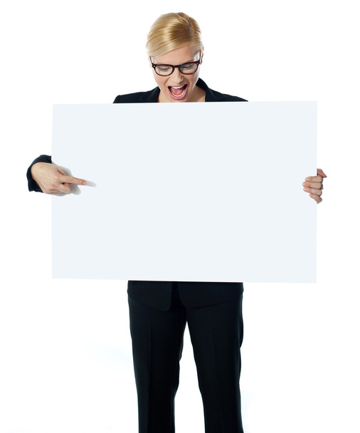 Successful business female pointing at white blank billboard - Фото, зображення