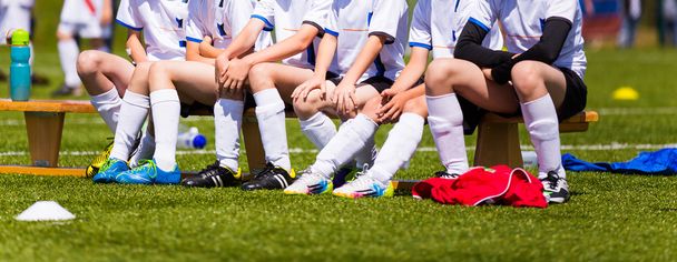 Soccer team; Reserve Players on a bench; Boys With Football Coac - 写真・画像