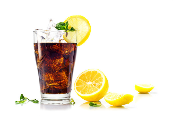 glass of cola or coke with ice cubes, lemon and peppermint garni - Fotografie, Obrázek