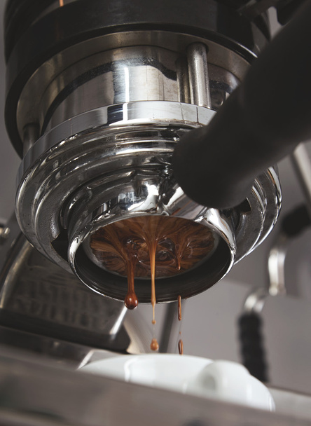 Closeup coffee drops fall from espresso machine - Fotografie, Obrázek