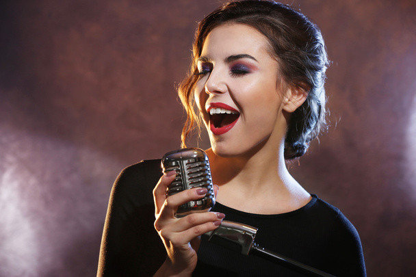 Young singing woman  - Фото, изображение