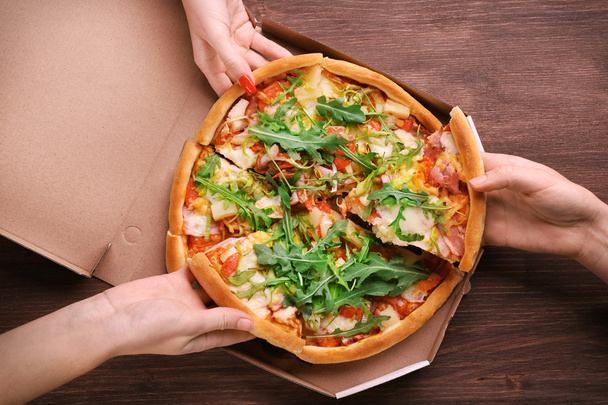 People hands with sliced pizza  - Foto, Bild