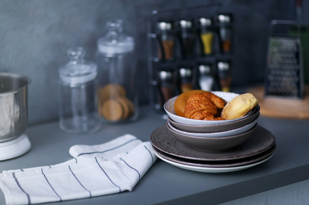 Utensils, towel and croissants - Foto, Bild