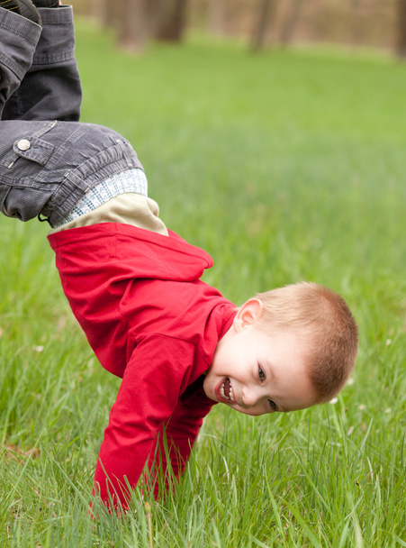 Joyeux petit garçon jouant dans l'herbe le beau jour du printemps
 - Photo, image