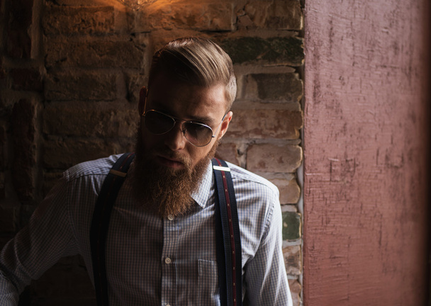 Cool young businessman with beard and eyeglasses - Фото, зображення