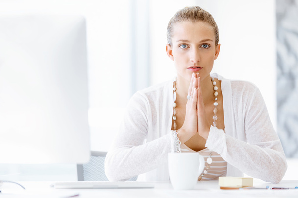 Attractive office worker sitting at desk - Photo, Image