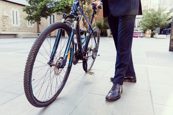 Successful businessman riding bicycle - Valokuva, kuva