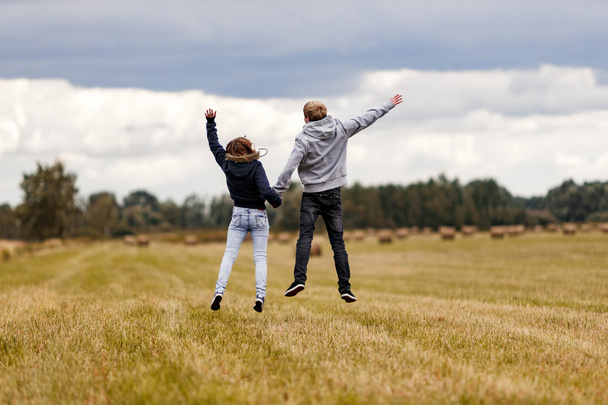 girl and guy jumping - Photo, Image