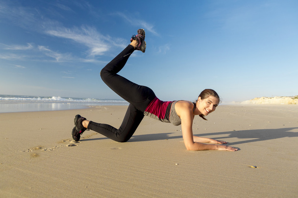 Woman exercising herself in the beach - Zdjęcie, obraz