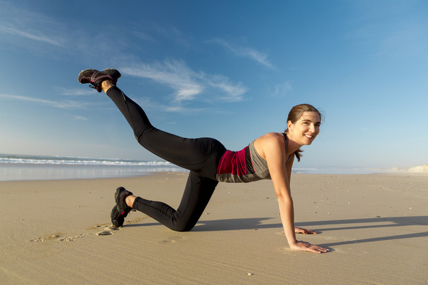 Woman exercising herself in the beach - Photo, Image