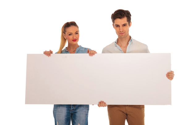 portrait of cute couple holding a billboard - Photo, Image