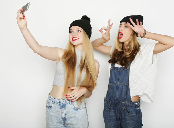 kaksi nuorta naista ottaa selfie matkapuhelimen kanssa - Valokuva, kuva