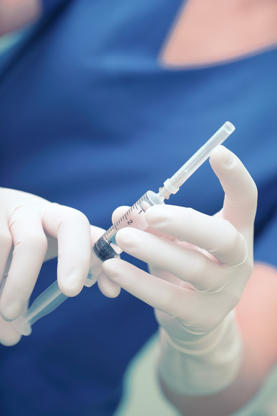 Nurse holding a syringe prepared for injection - Фото, зображення