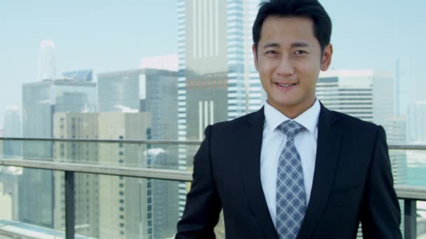 young Asian businessman standing on rooftop - Video, Çekim