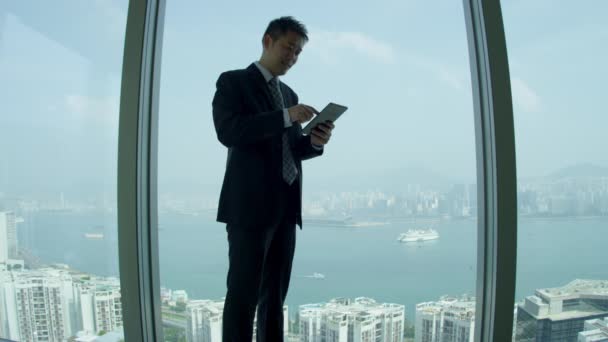 Asian share broker using mini tablet  - Footage, Video