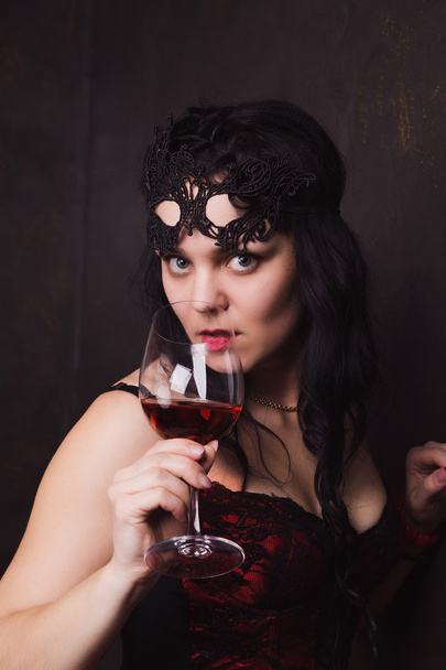 beautiful brunette woman holding a glass of red wine - Foto, imagen