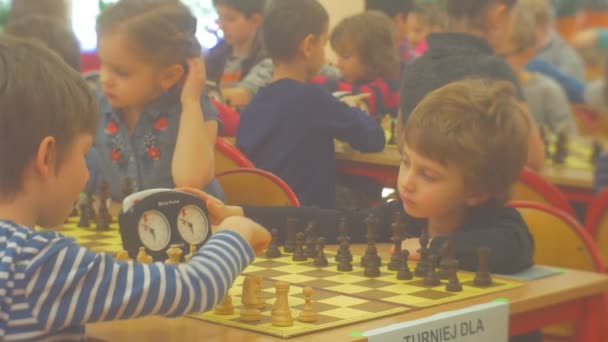 Kids Are Waiting For Start of Game of Chess Kids Are Talking Smiling Playing Chess at Chess Competition For Preschool Children in Opole Poland - Metraje, vídeo