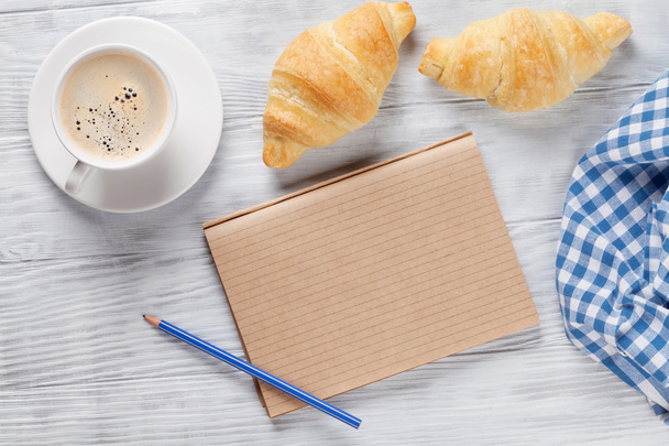 Fresh croissants, coffee and notepad - Фото, зображення