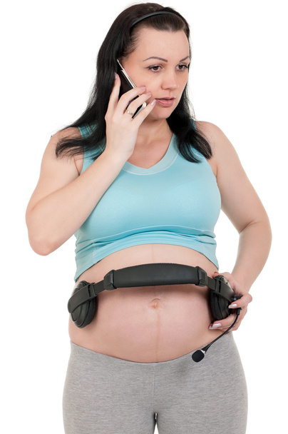 zwanger met koptelefoon - Foto, afbeelding