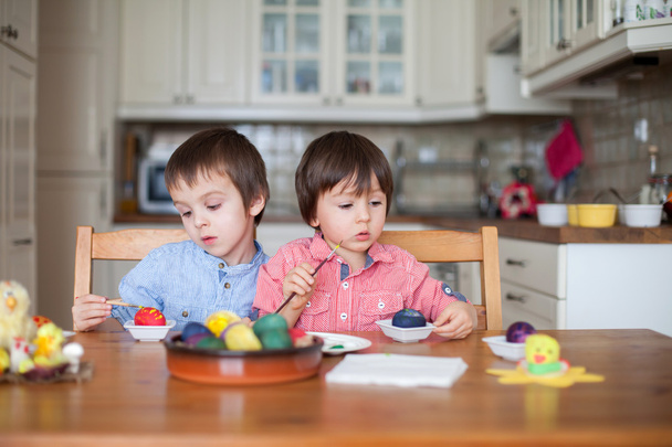 Two boys, coloring eggs for Easter - Photo, Image