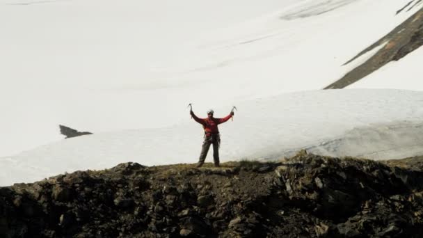 górski wspinacz cieszący się sukcesem na wysokim szczycie - Materiał filmowy, wideo
