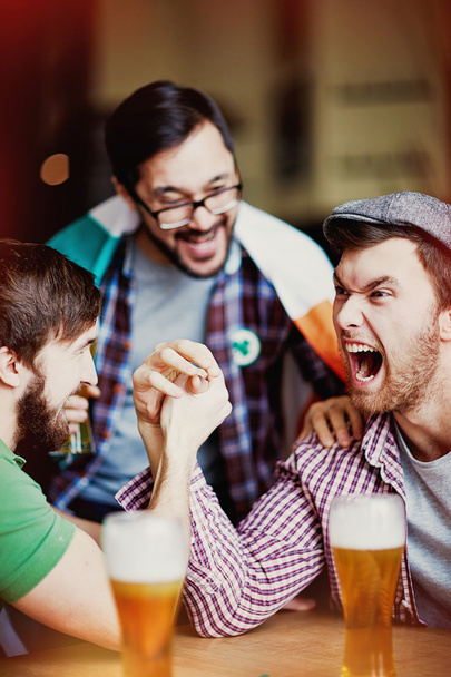 men arm wrestling in pub - Photo, image