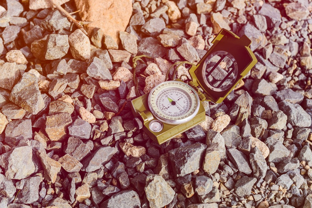 Compass instrument on gravel mountain hiking trail. - Photo, Image
