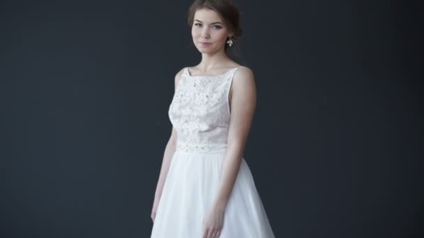 Beautiful young bride in white wedding dress smiling at camera - Záběry, video