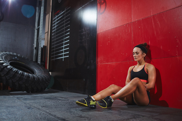 woman sitting in gym - Photo, image