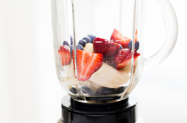close up of blender shaker with fruits and berries - Foto, Imagem