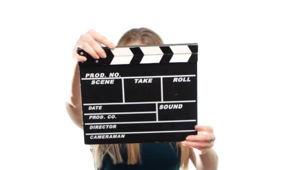 Elegant woman with sexy red lips holding clapper board and smiling, on white - Video