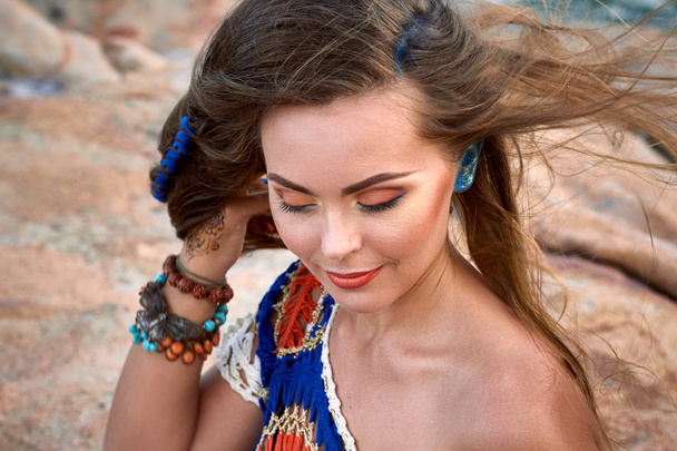 Beautiful girl, bright clothes, accessories, relax mood, summer stone beach - Photo, Image
