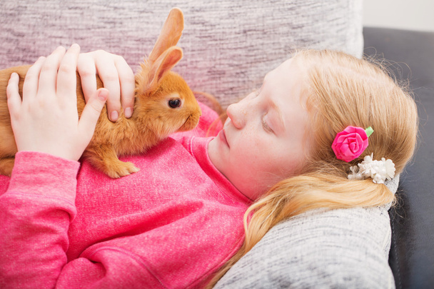 girl with rabbit outdoor - Фото, изображение