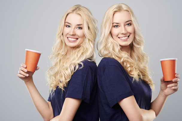 Girls with cups standing back to back - Photo, Image