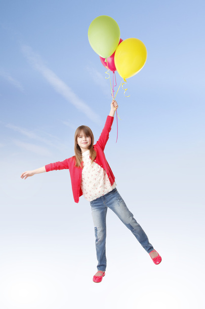 girl holding a bunch of  balloon - Foto, imagen
