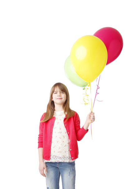 girl holding a bunch of balloons - 写真・画像
