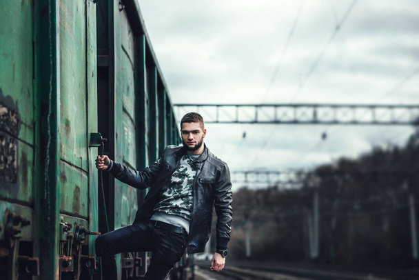 Man with beard walking on the railway - Fotó, kép