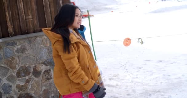 women walking through snow at resort - Footage, Video