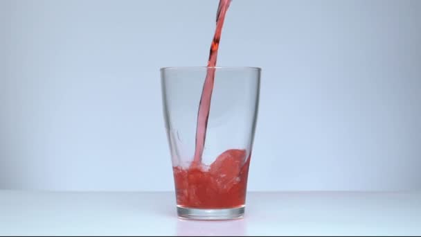 Slow motion red liquid poured into glass - Imágenes, Vídeo