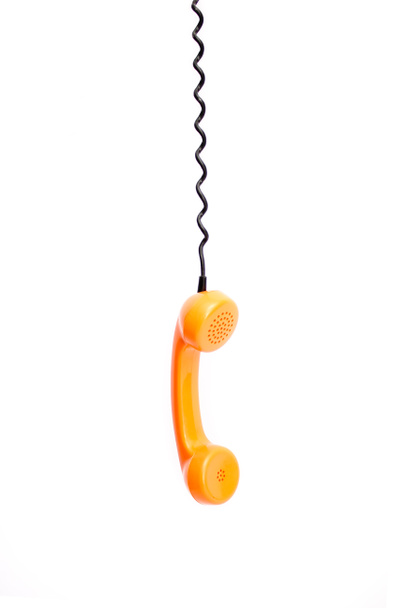 Tubo de teléfono retro naranja aislado sobre fondo blanco
. - Foto, Imagen