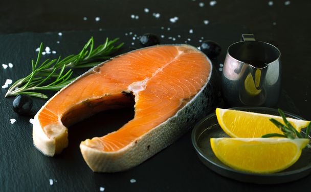 Raw salmon with lemon and spices  - Photo, Image