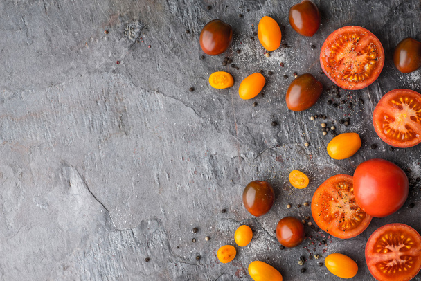 Tomatoes mix  with salt and pepper on the stone table - Foto, afbeelding
