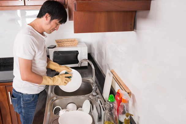 Вьетнамский мужчина моет посуду
 - Фото, изображение