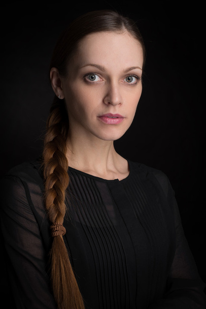 beautiful young woman on a dark background - Фото, изображение